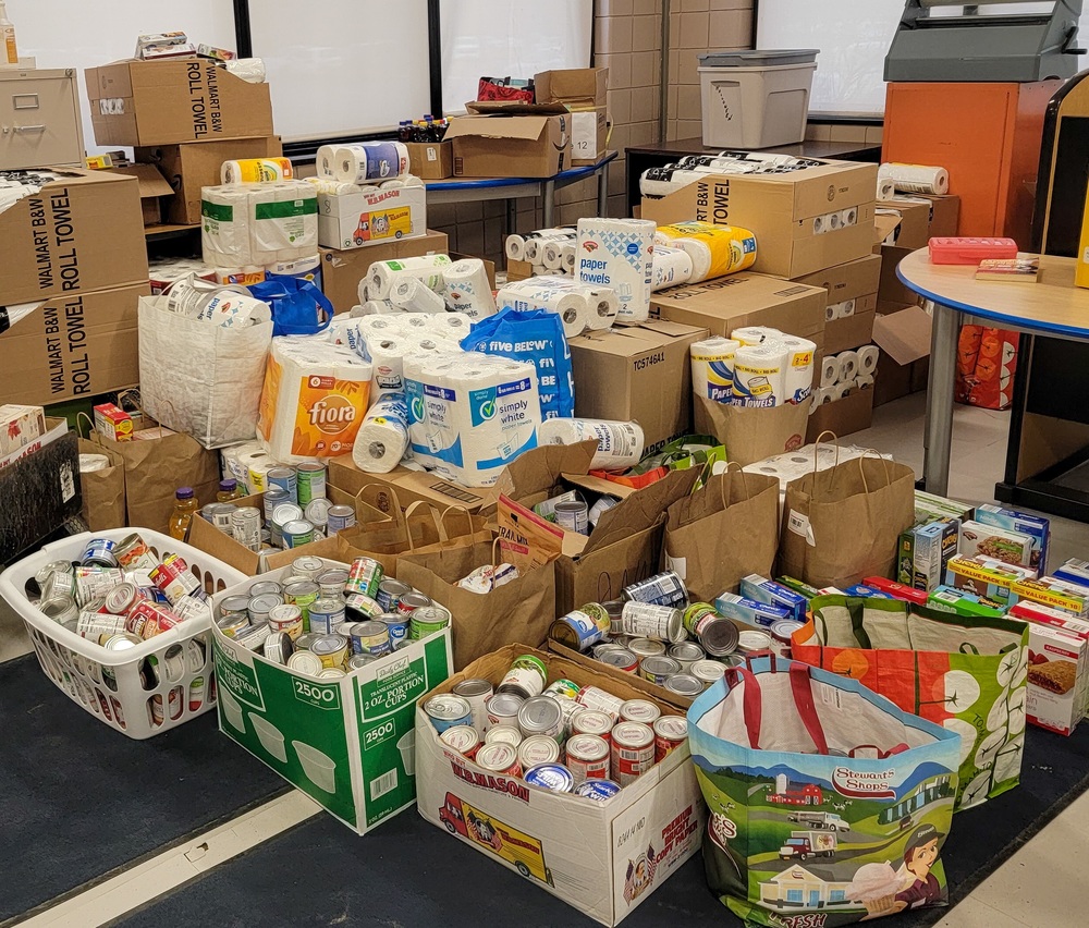 piles and boxes of donated food and household items
