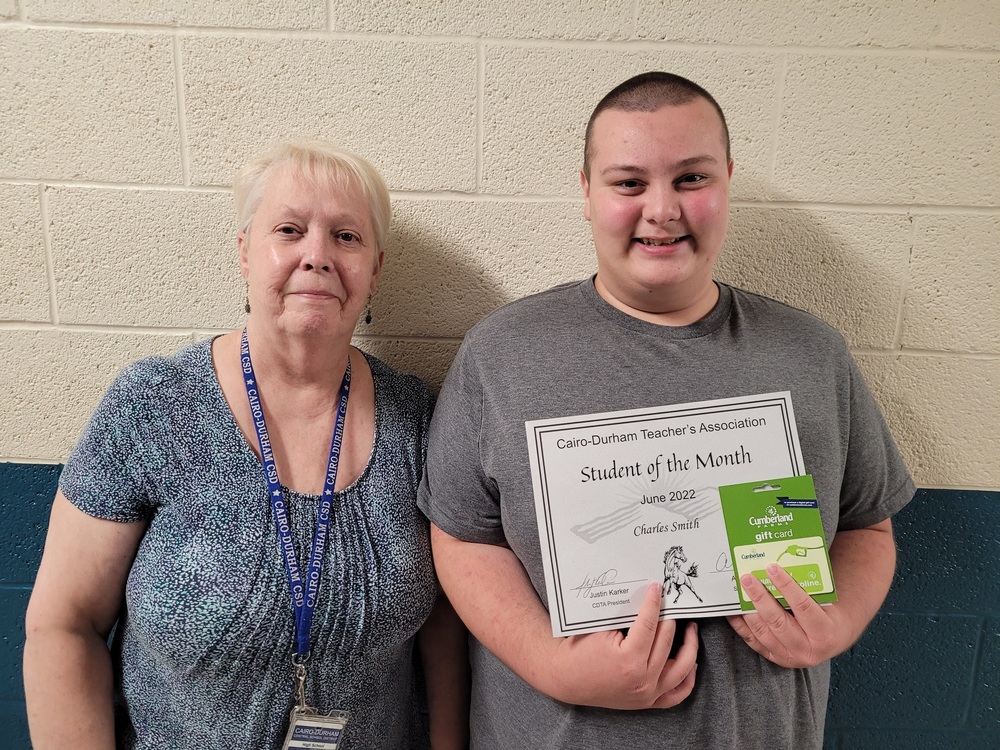 teacher Mrs. Vacca and high school student Charles Smith holding a certificate