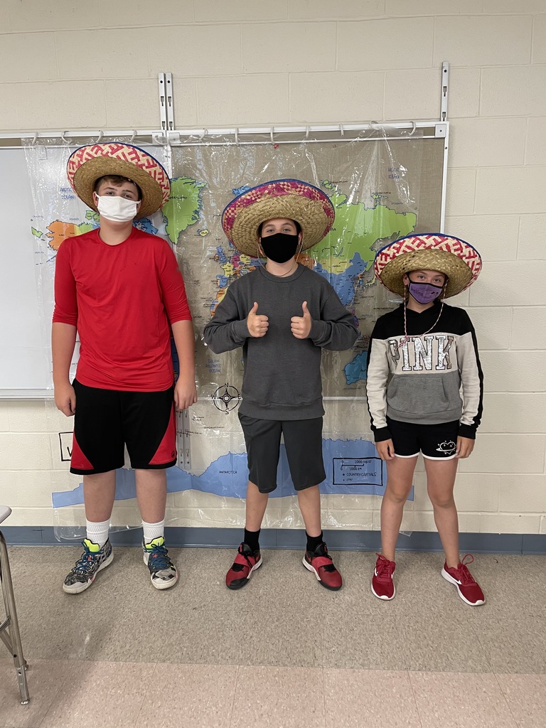 three middle school students wearing sombreros