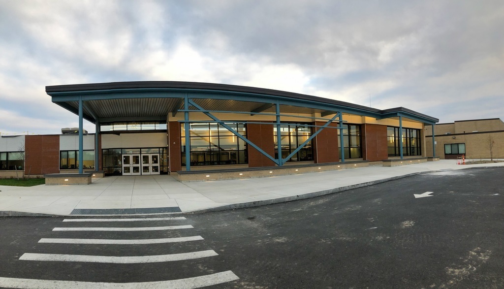 panoramic view of the new combined middle/high school entrance, with large windows into the Media Center