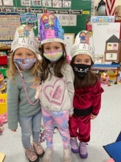 three pre-kindergarten girls with paper hats "I have a dream"