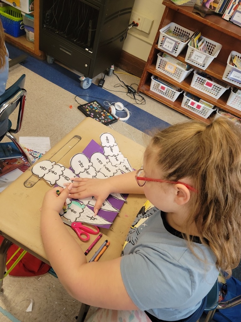 a third grade girl works on ice cream fractions at their desk