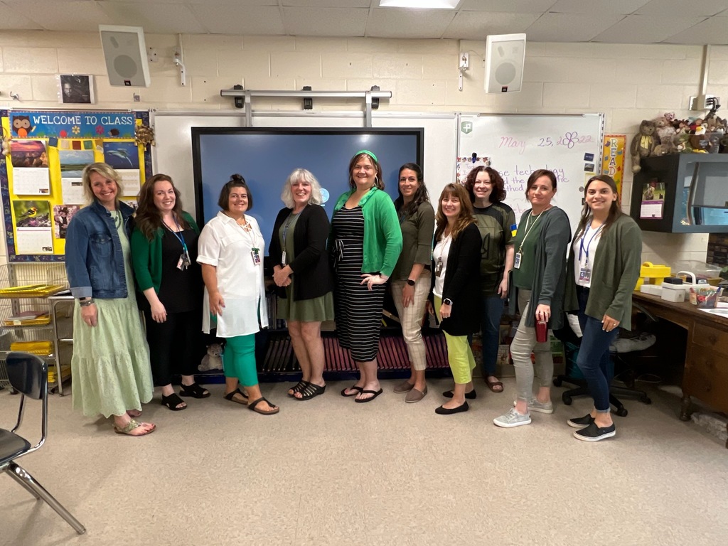 middle school staff wearing green items of clothing for Mental Health Month