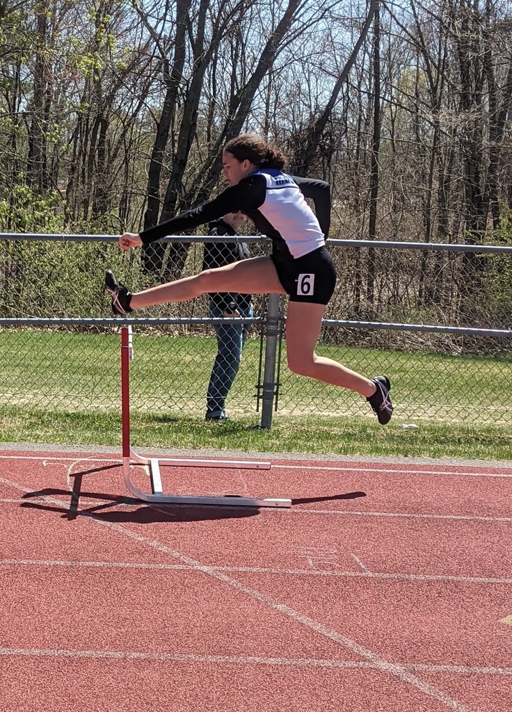 Mikayla Khadijah jumping a hurdle