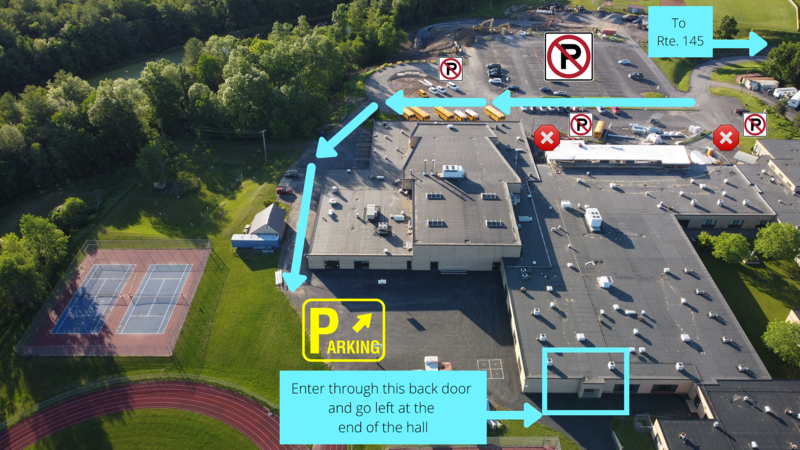 aerial view of campus with arrows directing traffic to the back of the building