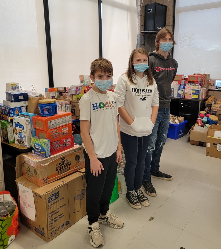 Student volunteers Ethan Searing-Burke, Madeline Gouza and Alex Gouza